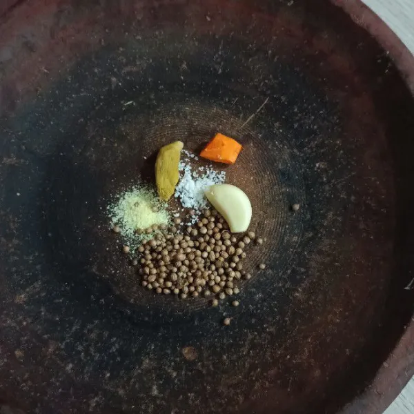 Masukkan bawang putih, jahe, kunyit yang sudah dikupas dari kulit arinya, butiran ketumbar, garam dan kaldu bubuk.