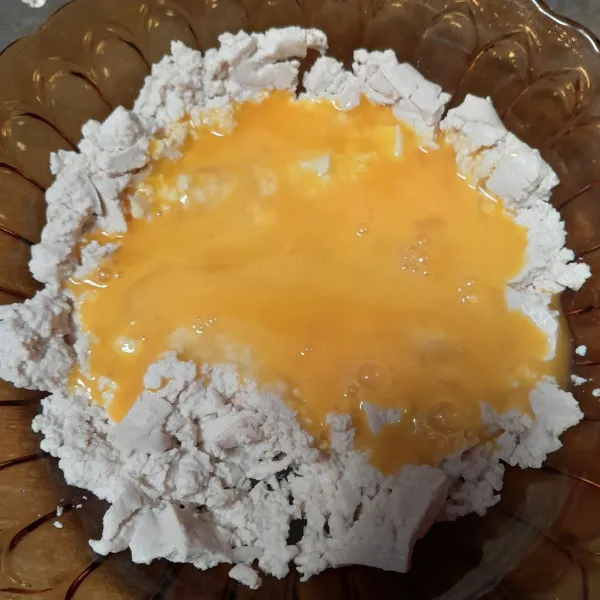Lalu masukkan kocokan telur ke dalam tahu, aduk rata.