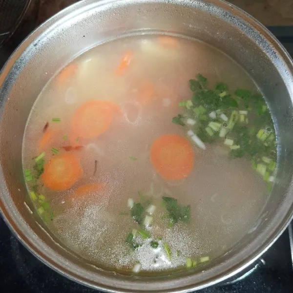Angkat ayam dari panci, lalu tambahkan irisan daun bawang dan seledri, koreksi rasanya dan matikan kompor.