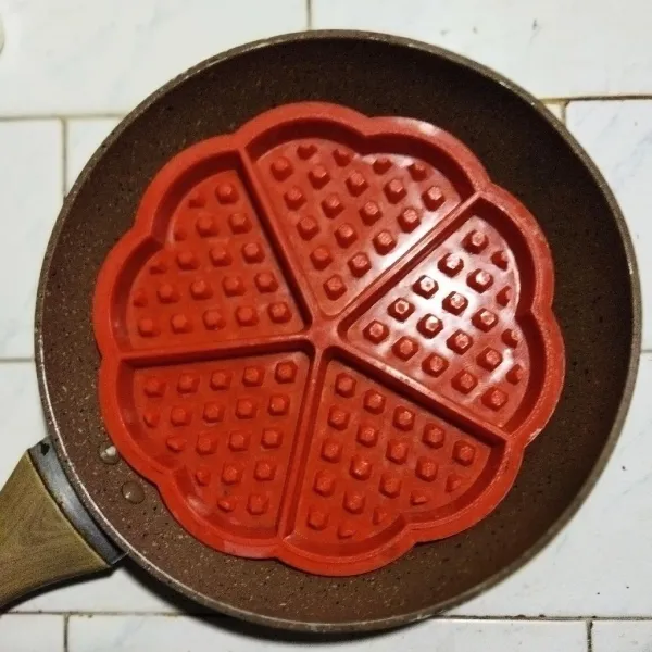 Siapkan cetakan waffle, aku pakai cetakan waffle silikon yang sudah ditambah lapisan adonan terigu dan air, lalu dipanggang hingga keras.