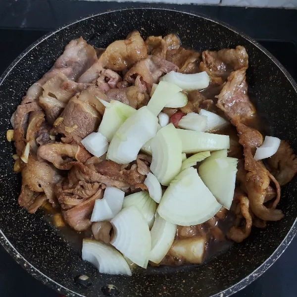 Masukkan bawang bombay, masak hingga layu dan bumbu saus meresap ke dalam daging.