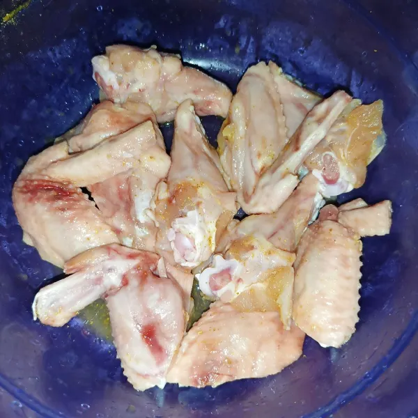 Bumbui sayap ayam dengan bumbu ikan goreng.