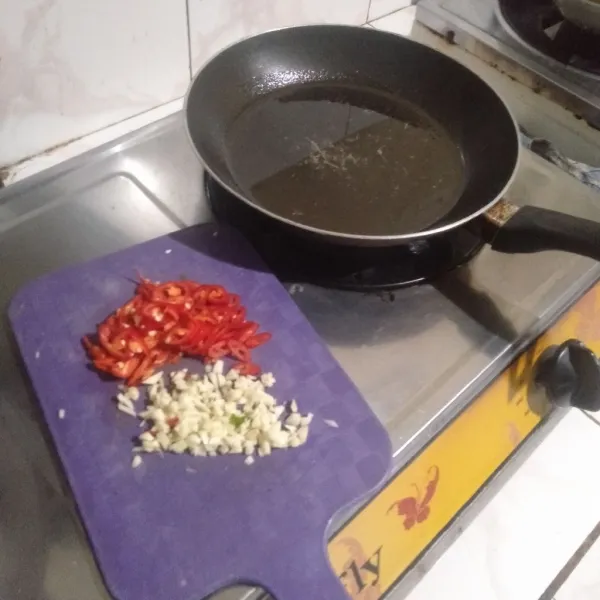 Lalu tumis bawang putih dan cabai dulu hingga harum di minyak yang sedikit dan sudah dipanaskan.