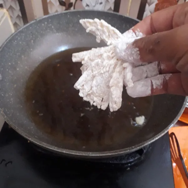 Panskan minyak dalam wajan. Baluri jamur dengan bahan tepung, lalu masukkan ke dalam minyak panas.