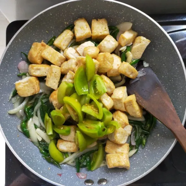 Kemudian masukkan tahu yang sudah digoreng tadi, masukkan juga tomat hijau iris.
