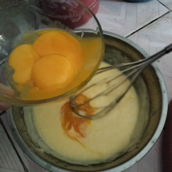 Tambahkan kuning telur satu persatu aduk sampai telur tercampur rata.