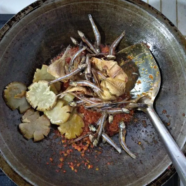 Matikan api. Masukkan teri nasi, ikan pres dan jengkol ke dalam wajan. Aduk rata dengan bumbu balado. Angkat dan sajikan dengan nasi hangat.