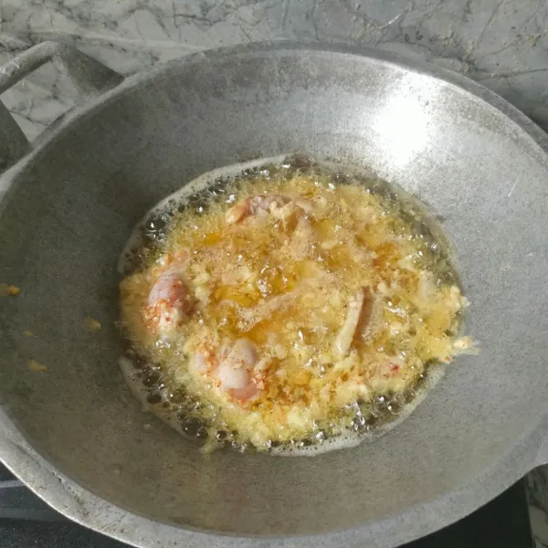 Goreng ayam yang sudah dimarinasi kedalam minyak panas menggunakan api sedang.