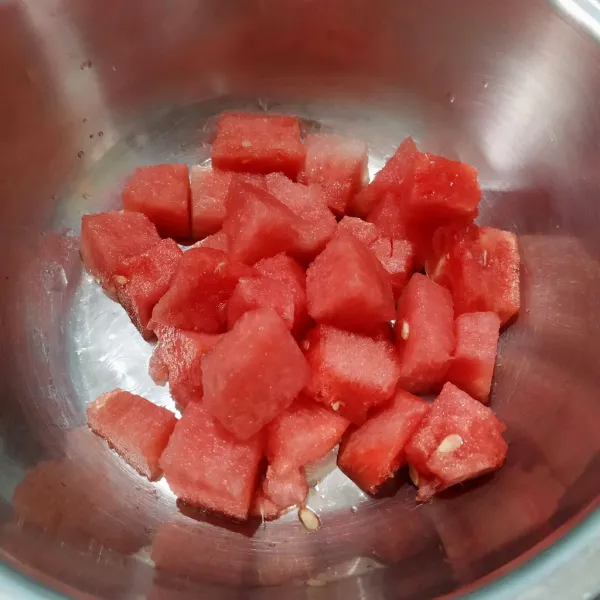 Kupas semangka lalu potong sesuai selera.