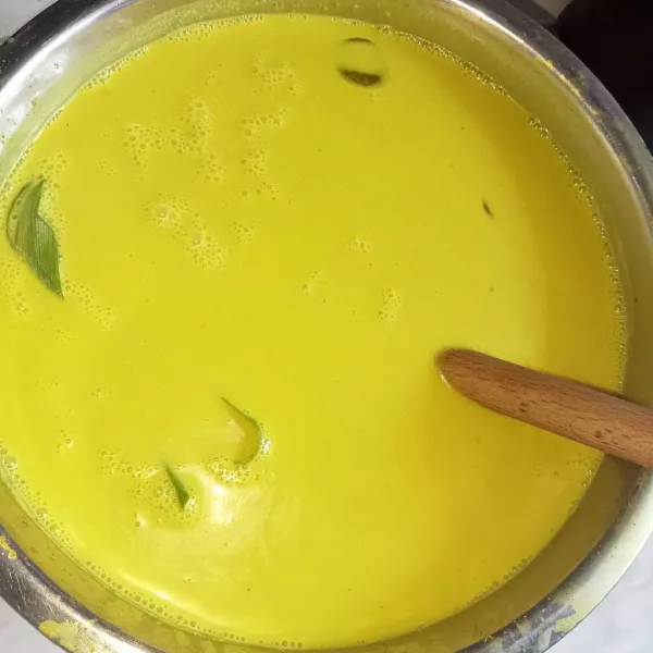 Campur semua bumbu nasi kuning. Masak hingga mendidih sambil diaduk supaya santan tidak pecah.