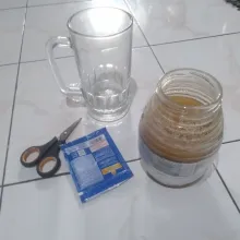 Dalam gelas tuangkan madu dan susu kental manis.