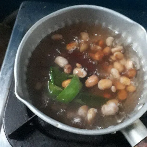 Dalam panci campurkan kacang merah bersama gula merah dan daun pandan. Rebus sampai kacang merah empuk.