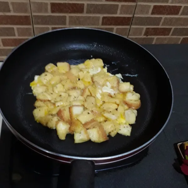 Olesi tipis teflon dengan margarin. Tuang adonan roti telur dan masak dengan api kecil hingga bagian bawah matang.
