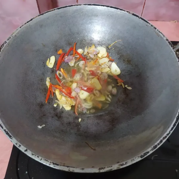 Tumis irisan bawang putih dan bawang merah. Masukkan cabe merah besar.