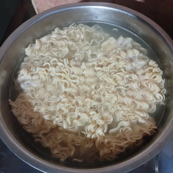 Didihkan air, masukkan mie kuning. Rebus setengah matang. Angkat, tiriskan dan sisihkan.