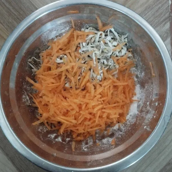 Serut wortel lalu campurkan dengan kecambah dalam satu wadah.