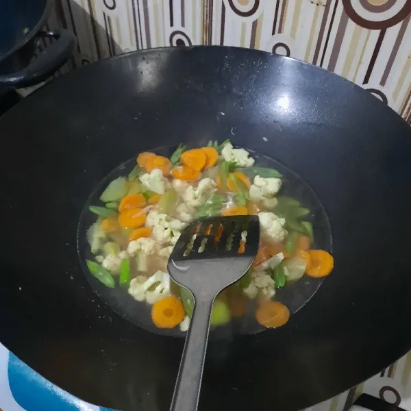 Tambahkan air. Kemudian masukkan telur yang sudah didadar tadi.
