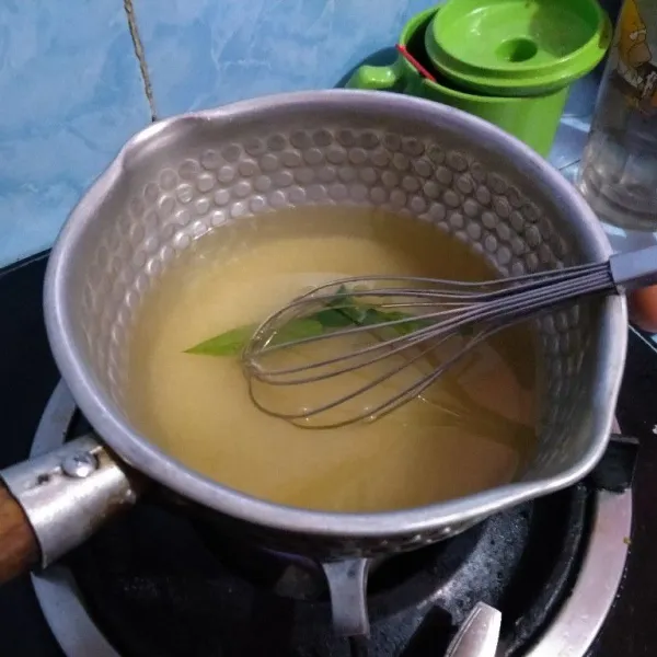 Panaskan air, daun pandan, gula pasir dan garam dengan api kecil, hanya sampai gula larut saja tidak usah menunggu mendidih. Dinginkan.