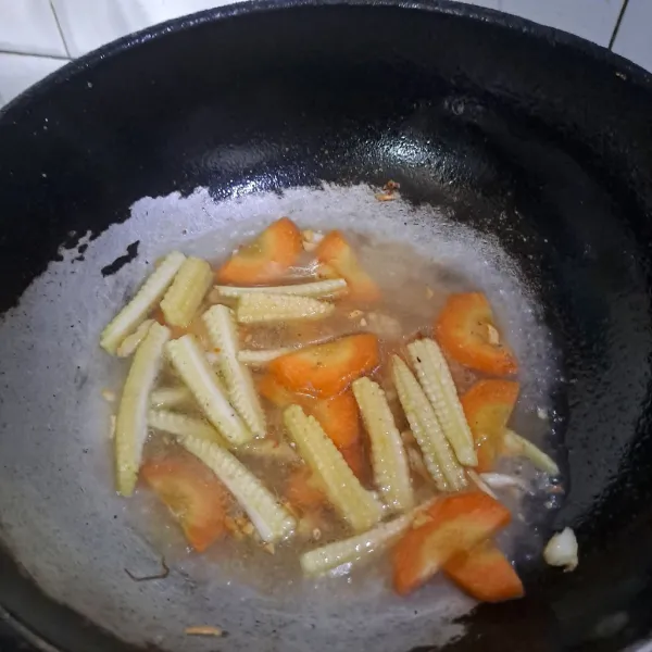 Masukan wortel dan jagung putren lalu tuang air.