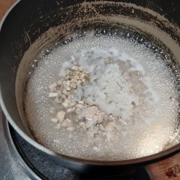 Masukkan nasi, rebus hingga air meresap dan nasi jadi lebih lembut. Matikan api, biarkan hangat.