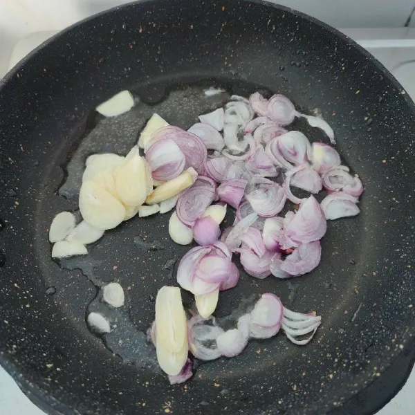 Panaskan minyak, tumis bawang merah dan bawang putih yang sudah diiris tipis hingga harum dan layu.