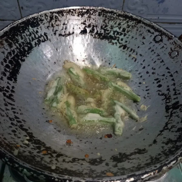 Baluri buncis dengan adonan tepung kemudian goreng sampai krispi.