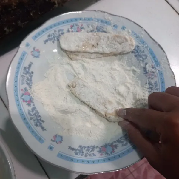 Baluri tempe yang sudah dimarinasi dengan tepung serbaguna kering.