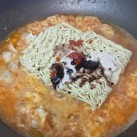 Tambahkan air & telur, aduk rata. Masukkan mie & bumbunya, aduk merata.