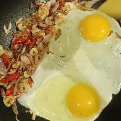 Sisihkan tumisan bawang ke pinggir teflon, lalu masukkan telur, kemudian orak arik telur.