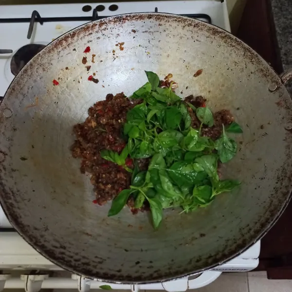 Masukan daun kemangi masak hingga layu.