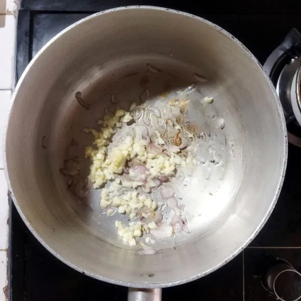 Tumis bawang putih dengan minyak hingga harum di atas teflon.