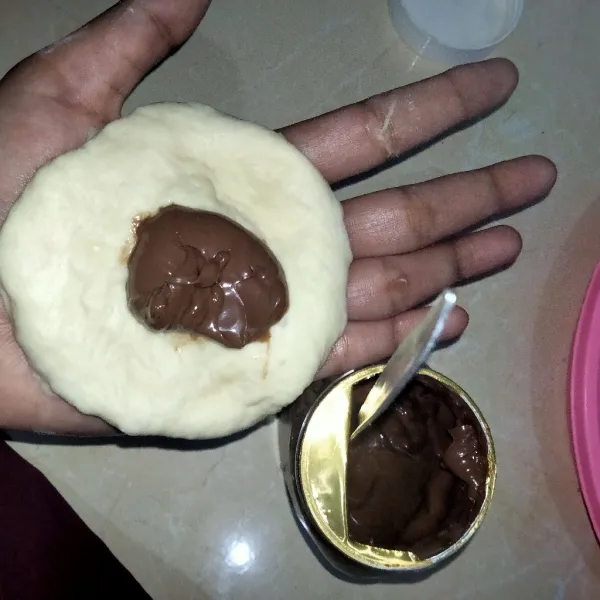 Pipihkan adonan lalu beri selai coklat ditengahnya kemudian bulatkan