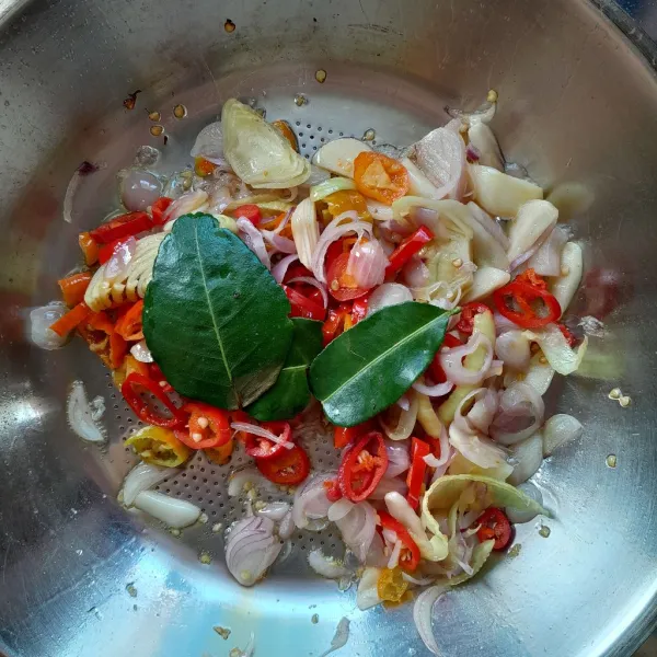 Kemudian masukkan daun jeruk. Tumis hingga harum dan sedikit kering.