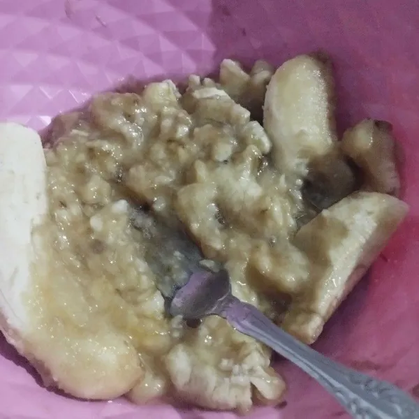 Hancurkan buah pisang dengan garpu sampai halus.