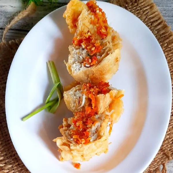 Sajikan tahu dengan toping sambal di atasnya.