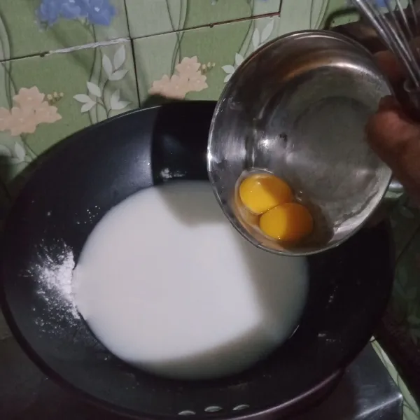 Dalam panci masuk kan tepung terigu, maizena, SKM, kuning telur,  aduk rata, masuk kan air kelapa, aduk masak di atas kompor hingga mengental