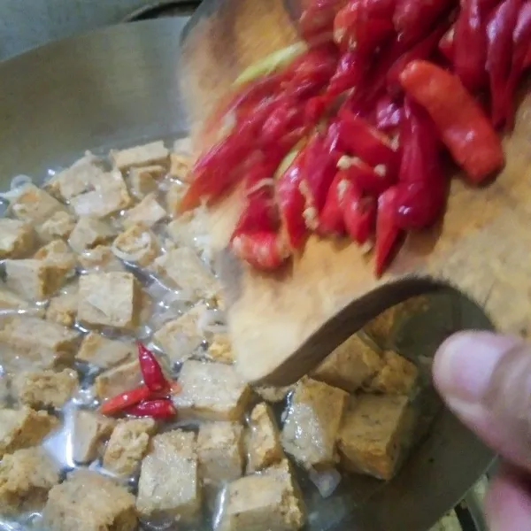 Setelah air mendidih masukan oncom dan irisan cabai rawit. Aduk rata sebentar, kemudian ditutup ,masak hingga mendidih kembali.