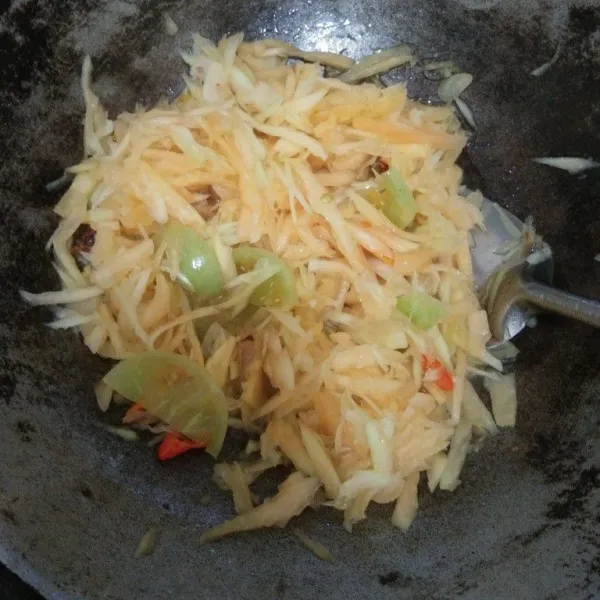 Masukkan irisan pepaya muda yang telah ditiriskan dari air