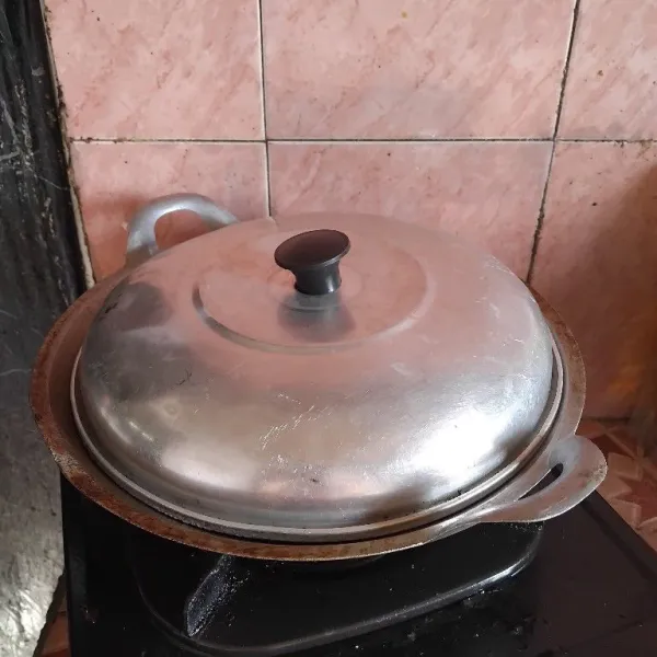 Tutup dengan tutup panci agar terong masak sempurna