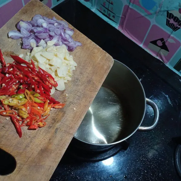 Panaskan minyak, kemudian tumis kedua cabe dan kedua bawang
