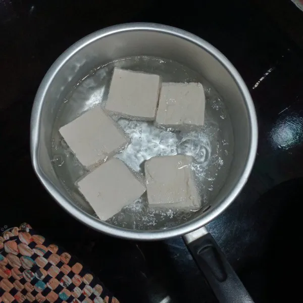 Didihkan secukupnya air  lalu masukan tahu, masak 5-7 menit