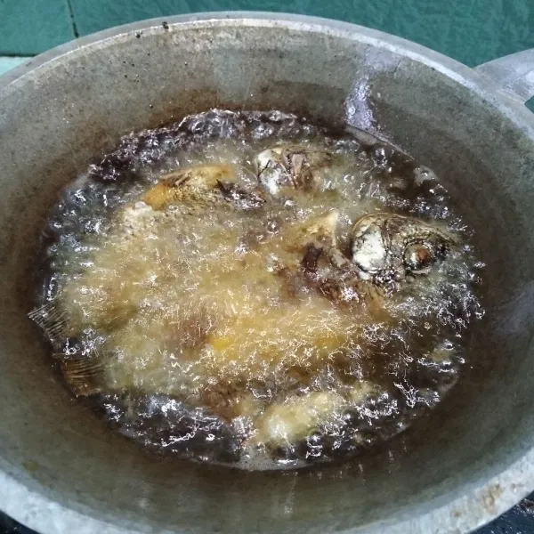 Goreng ikan yang sudah dimarinasi sampai tingkat kematangan yang diinginkan.