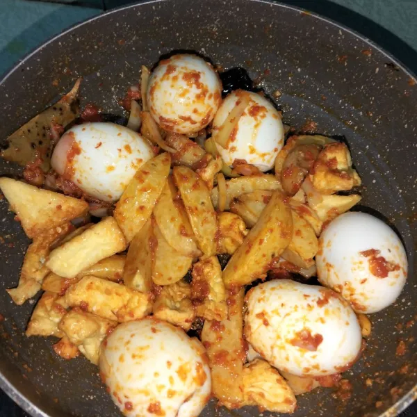 Masukkan telur, tahu dan kentang. Aduk sampai rata.