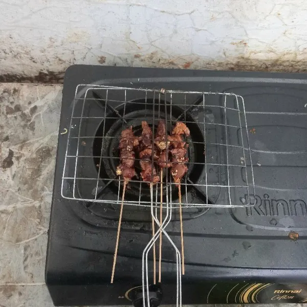 Oleskan kecap yang diberi dengan margarin ke bagian sisi sate sampai berulang kali hingga matang.