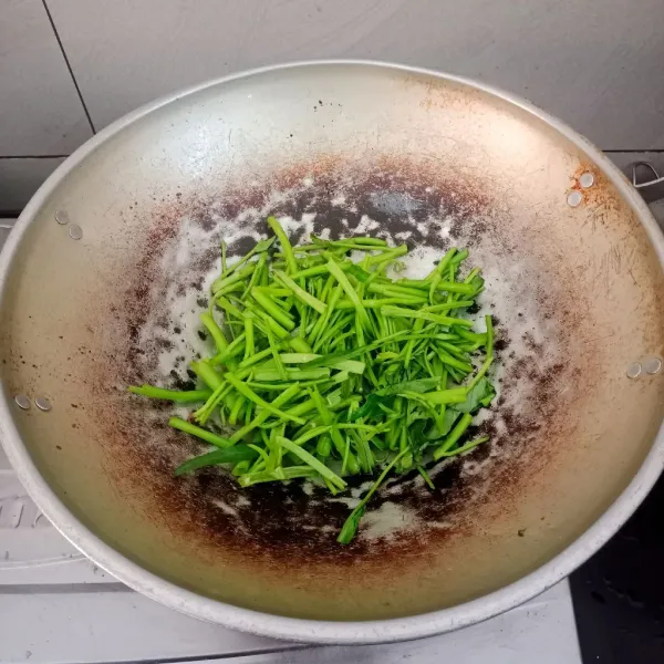 Masukan terlebih dahulu batang kangkung, aduk balik sampai agak layu