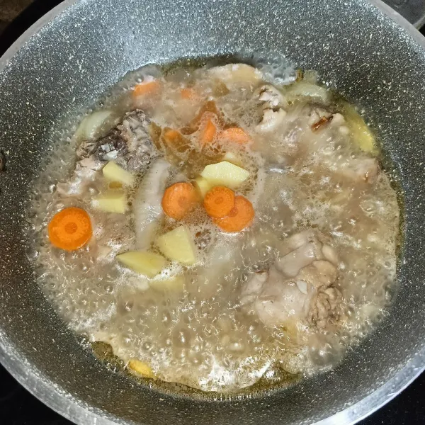 Setelah mendidih masukkan kentang dan wortel, masak dengan api sedang.