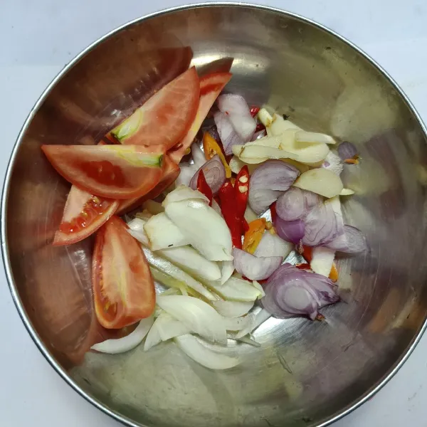Iris-iris bawang putih, bawang merah, bawang bombay, cabai, dan tomat.