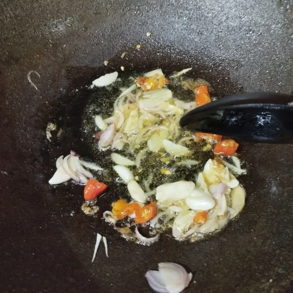 Potong-potong bawang merah, bawang outih dan cabe merah. Lalu panaskan minyak goreng. Masukkan bawang merah dan bawang putih. Tumis sampai harum, masukkan cabe merah. Adu merata, tambahkan udang rebon, aduk rata.