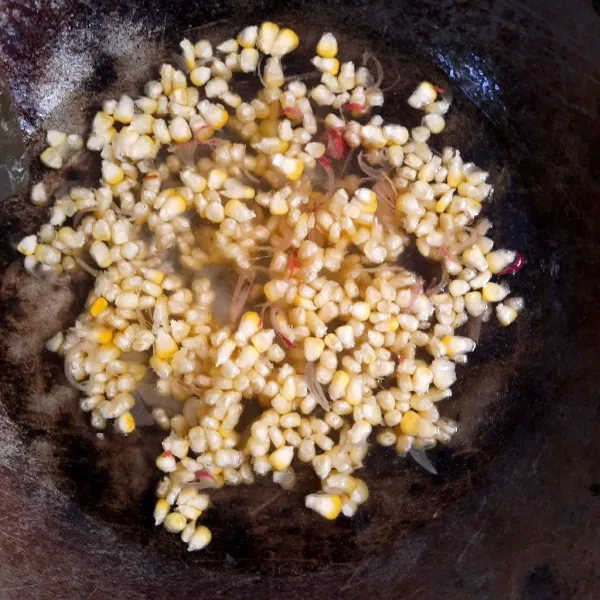 Lalu, tambahkan air dan masukkan jagung. Masak jagung hingga setengah matang.