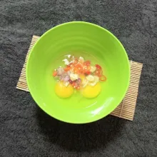 Masukkan telur dan irisan cabai rawit, bawang merah, dan bawang putih.